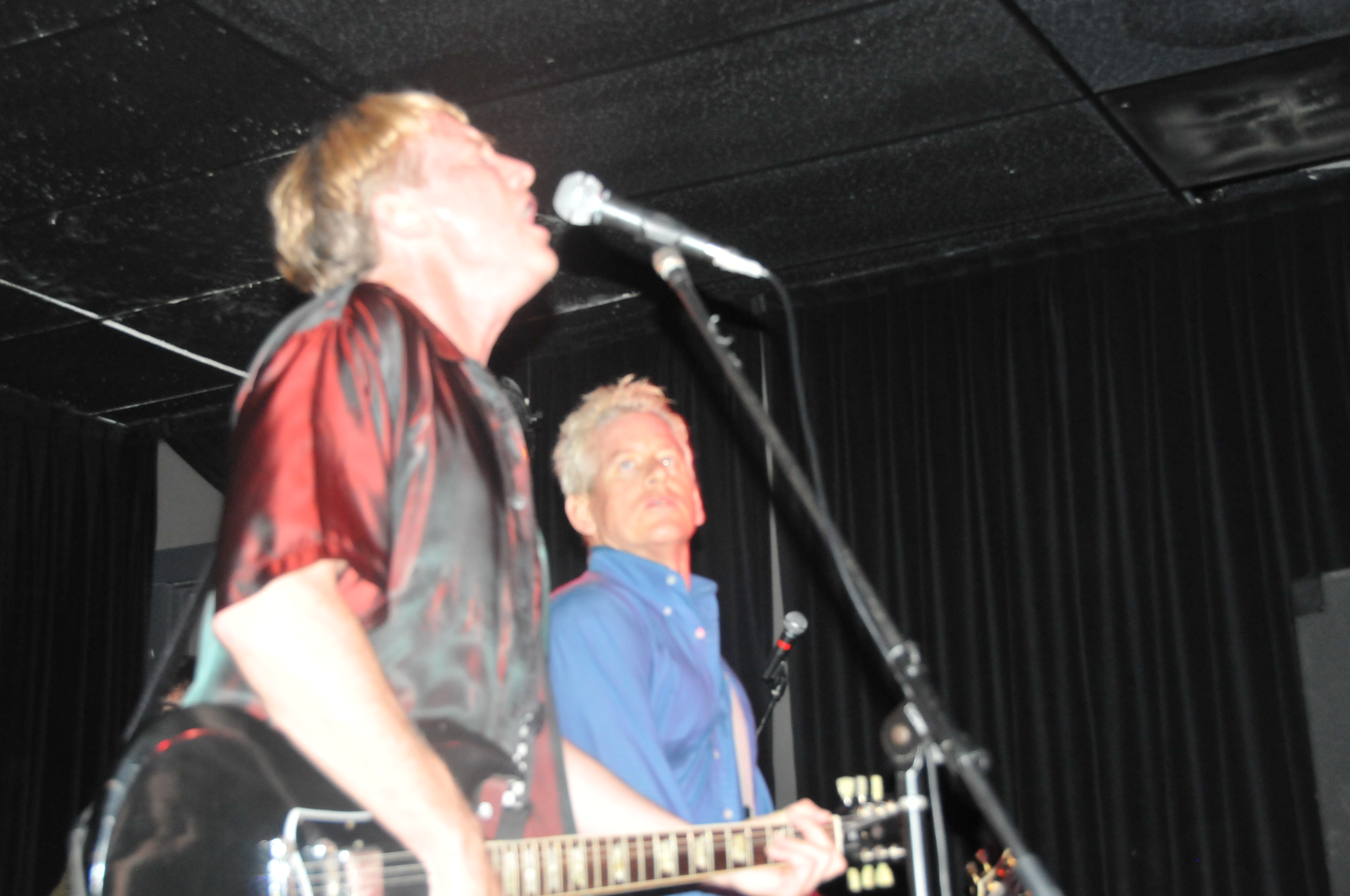 The Outlets performing at microphones